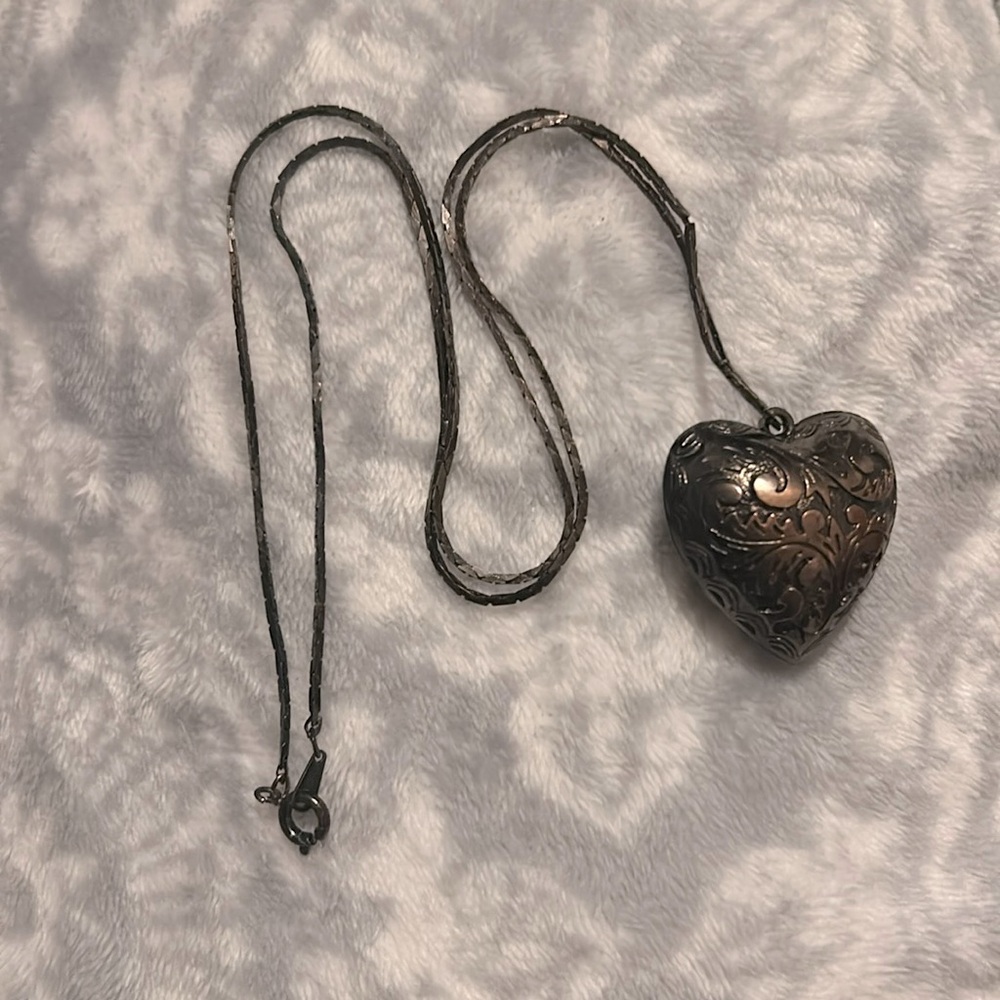 This is a bronze and black looking necklace.